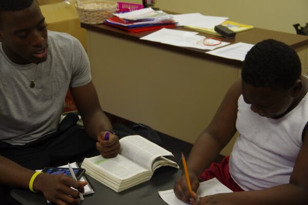 CSM Intern, Josh Hubbard, tutoring a camper at Bethel